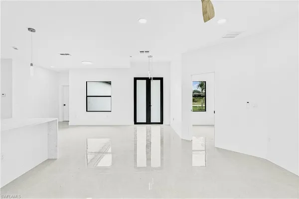 a large white room with a white cabinet and mirror
