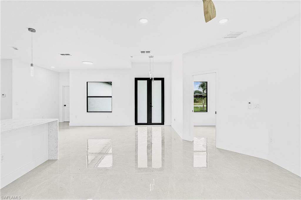 343 Pullman Street Lehigh Acres, FL 33974 - Photo 7 of 48 a large white room with a white cabinet and mirror