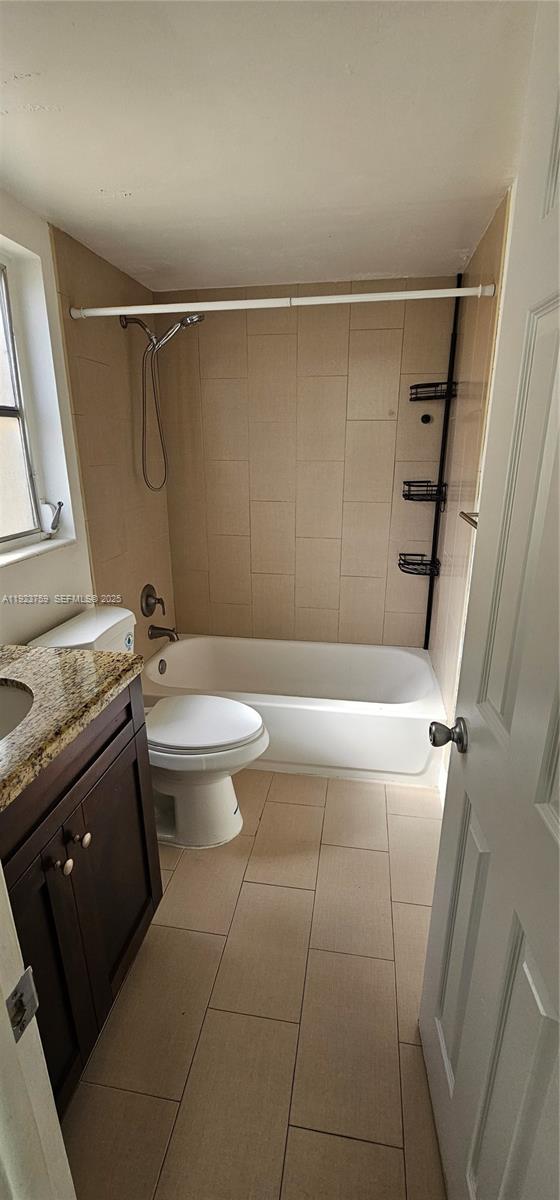 7775 Southwest 86th Street, Unit F1301 Miami, FL 33143 - Photo 12 of 20 a bathroom with a granite countertop sink toilet and shower