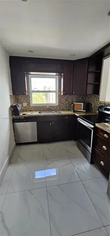 a kitchen with stainless steel appliances granite countertop a sink and a stove