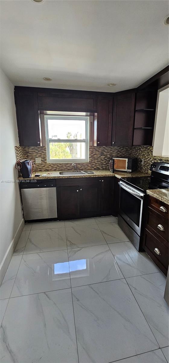 7775 Southwest 86th Street, Unit F1301 Miami, FL 33143 - Photo 14 of 20 a kitchen with stainless steel appliances granite countertop a sink and a stove