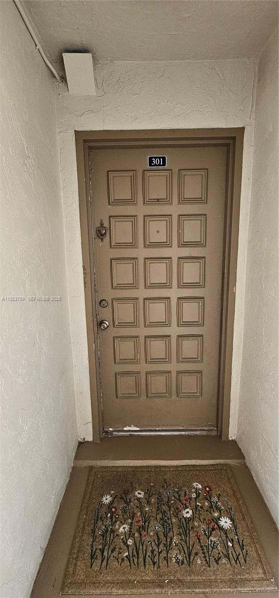 7775 Southwest 86th Street, Unit F1301 Miami, FL 33143 - Photo 3 of 20 a view of wooden door