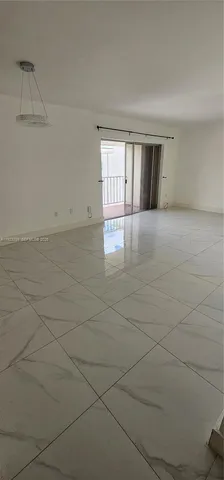 a view of an empty room with chandelier