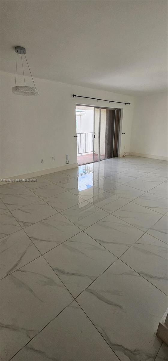 7775 Southwest 86th Street, Unit F1301 Miami, FL 33143 - Photo 9 of 20 a view of an empty room with chandelier