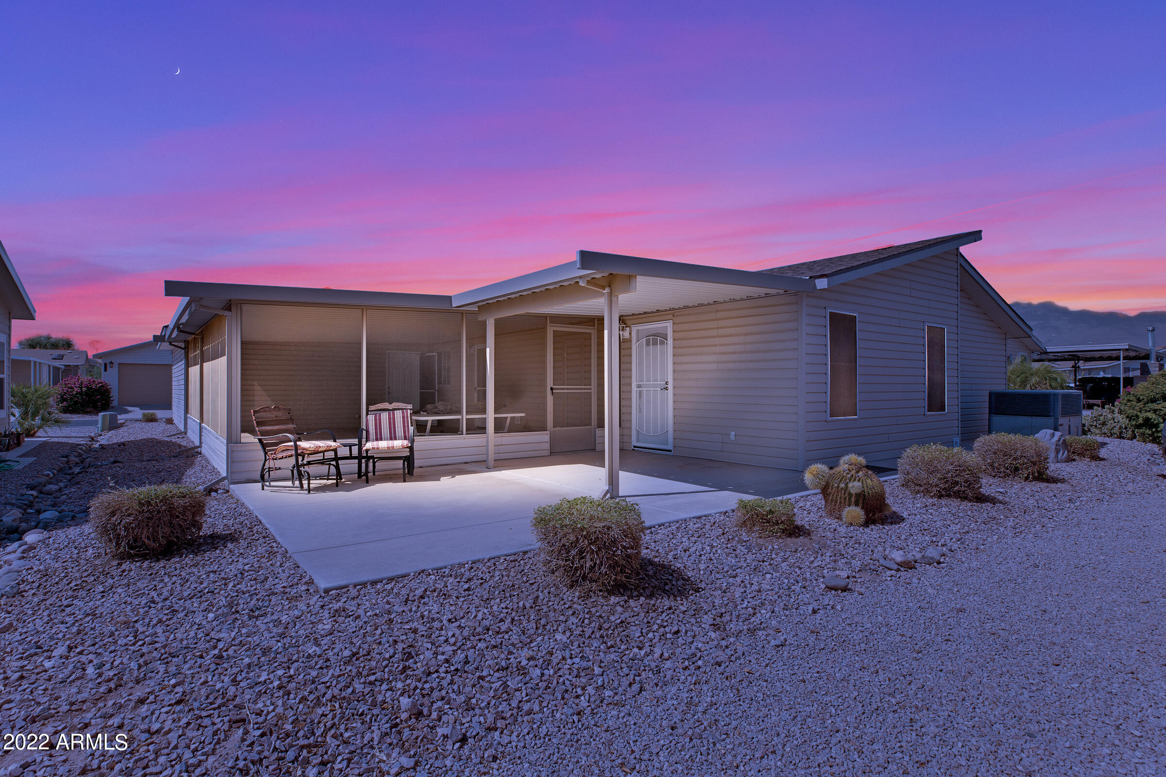3301 South Goldfield Road, Unit 4083 Apache Junction, AZ 85119 - Photo 12 of 12 a front view of a house with patio