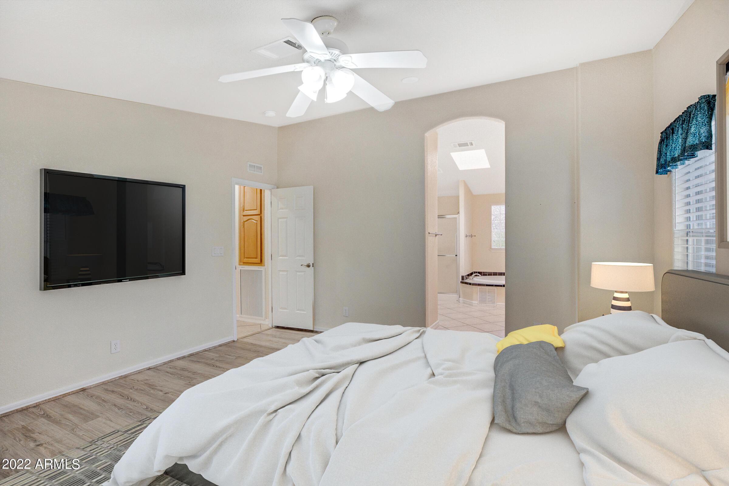 3301 South Goldfield Road, Unit 4083 Apache Junction, AZ 85119 - Photo 6 of 12 a bedroom with a large bed and a flat screen tv
