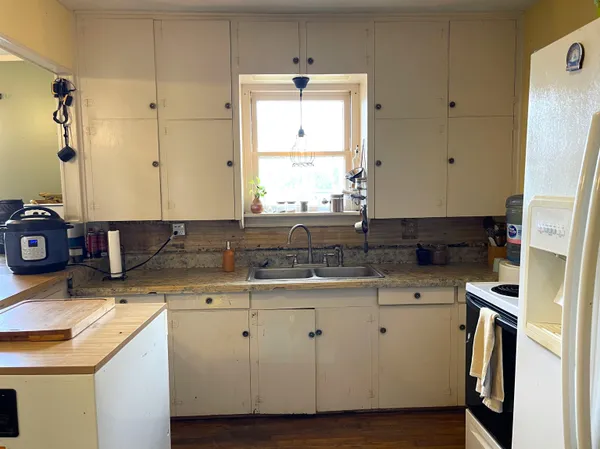 a kitchen with a sink and cabinets