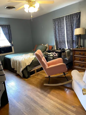 a bedroom with two beds and a lamp