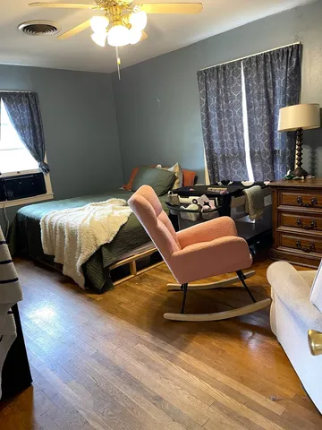 a bedroom with two beds and a lamp