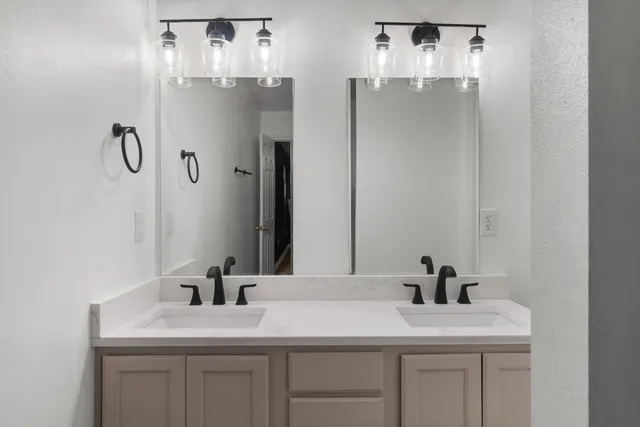 a bedroom with a bed and a desk