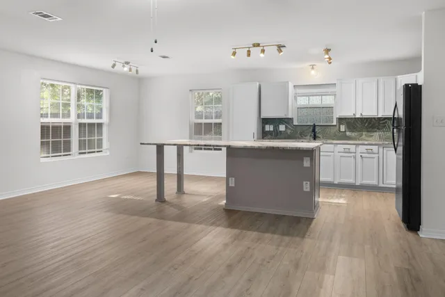 a kitchen with granite countertop white cabinets and a counter top space