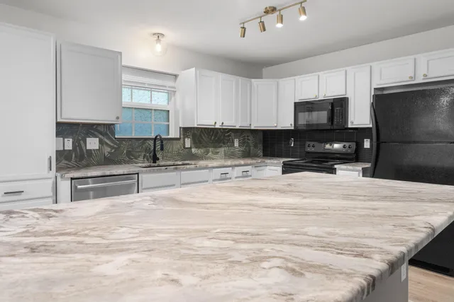a bathroom with a double vanity sink mirror and toilet