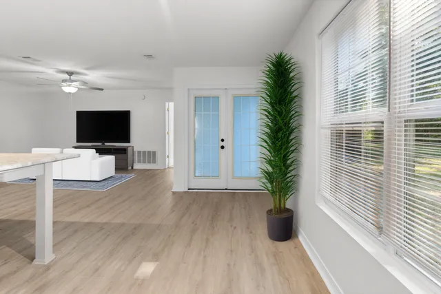 wooden floor in an empty room with a window
