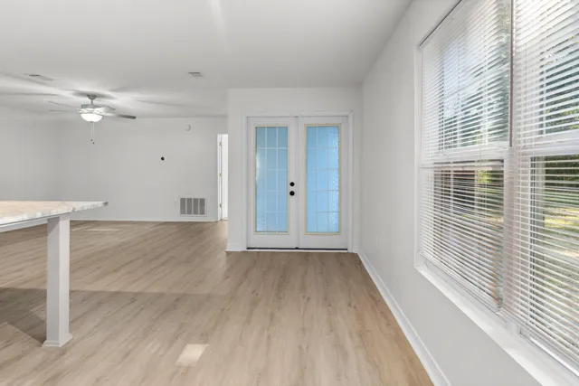 a bedroom with a bed lamp and window