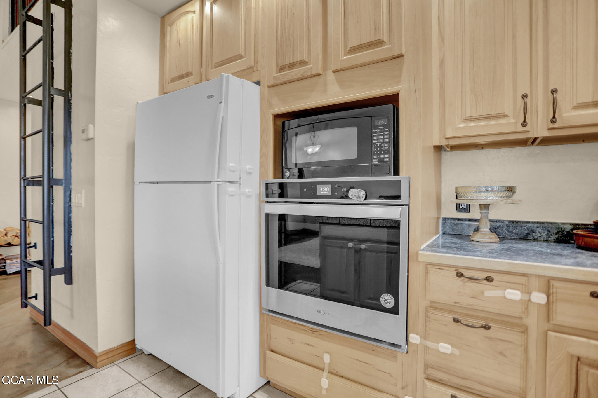 91 3rd Avenue Parshall, CO 80468 - Photo 3 of 48 a kitchen with granite countertop white cabinets and stainless steel appliances