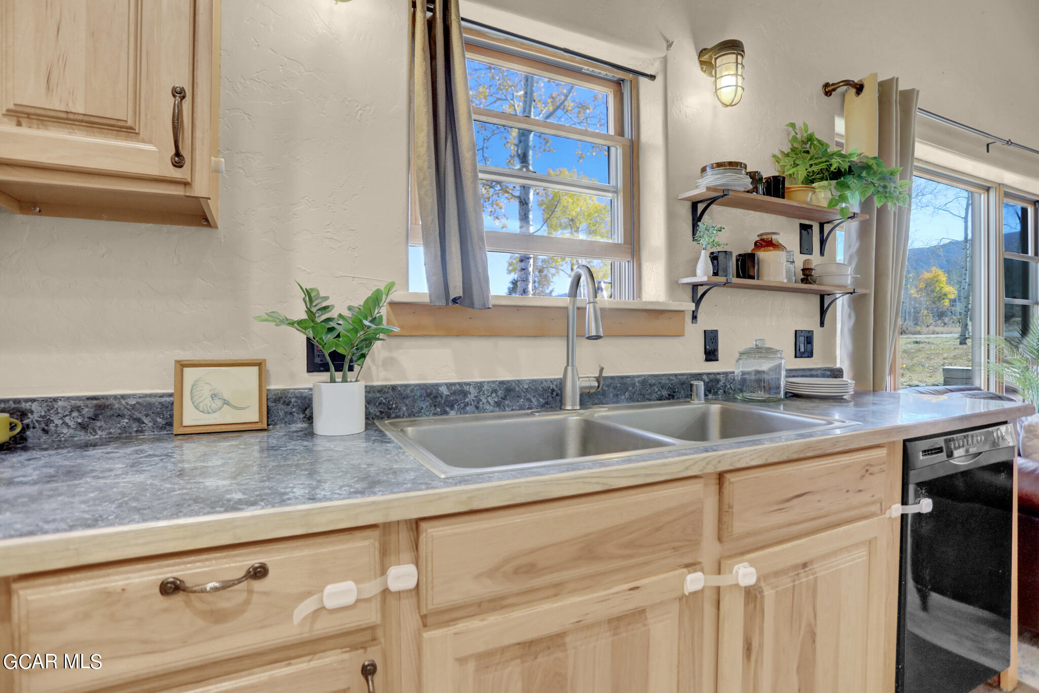 91 3rd Avenue Parshall, CO 80468 - Photo 5 of 48 a kitchen with granite countertop a sink and a window