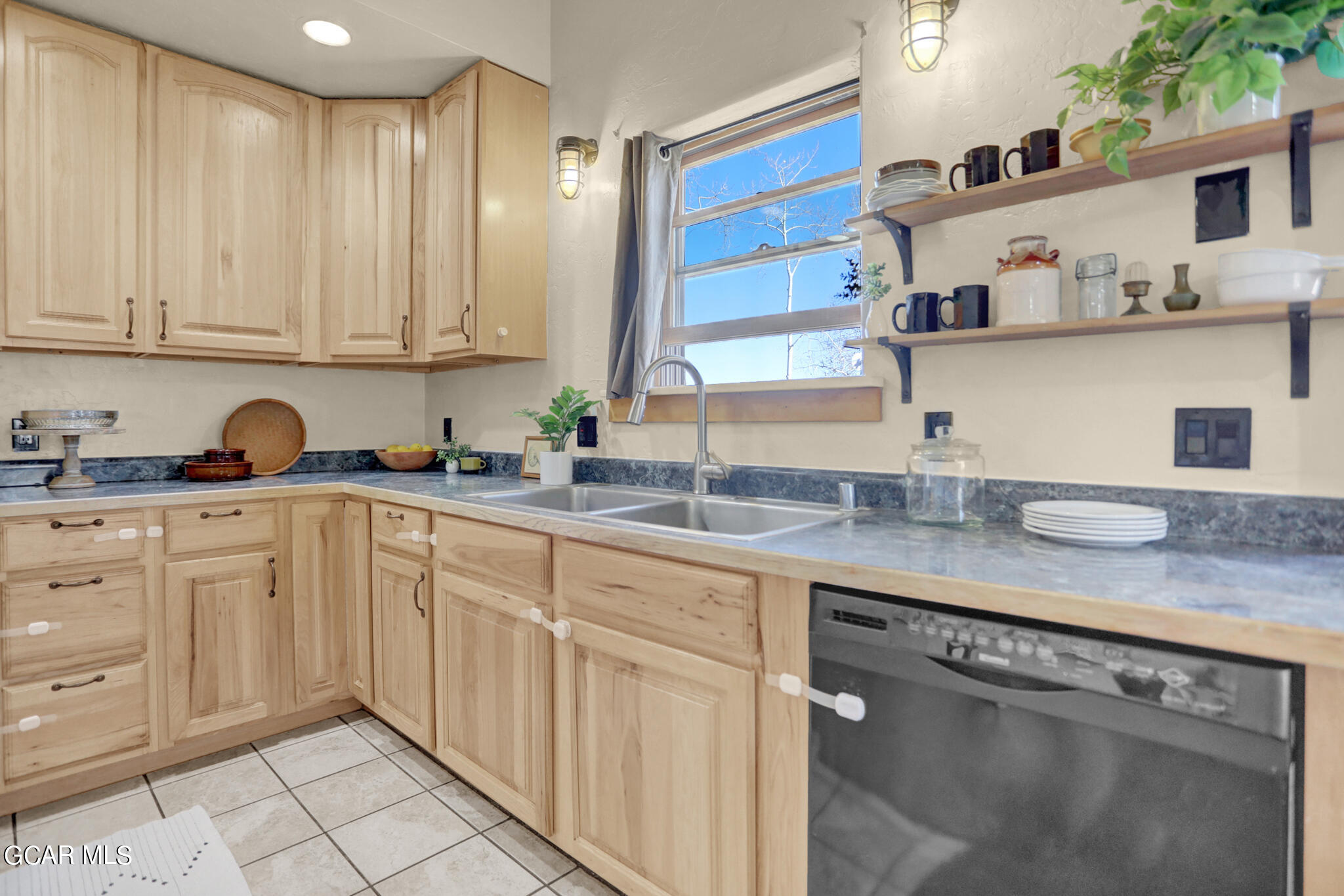 91 3rd Avenue Parshall, CO 80468 - Photo 6 of 48 a kitchen with stainless steel appliances granite countertop white cabinets a sink and dishwasher