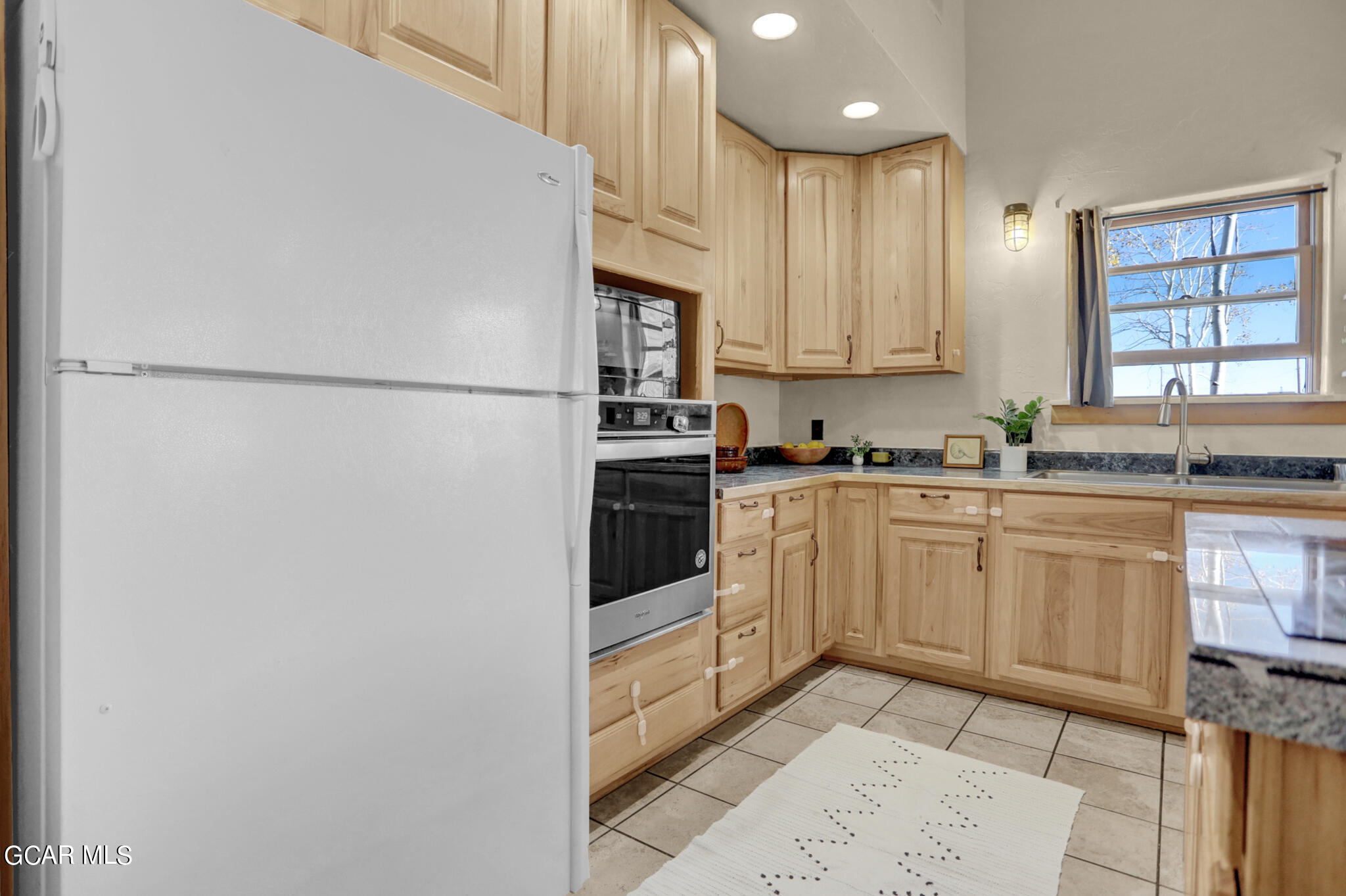 91 3rd Avenue Parshall, CO 80468 - Photo 7 of 48 a kitchen with white cabinets and white appliances