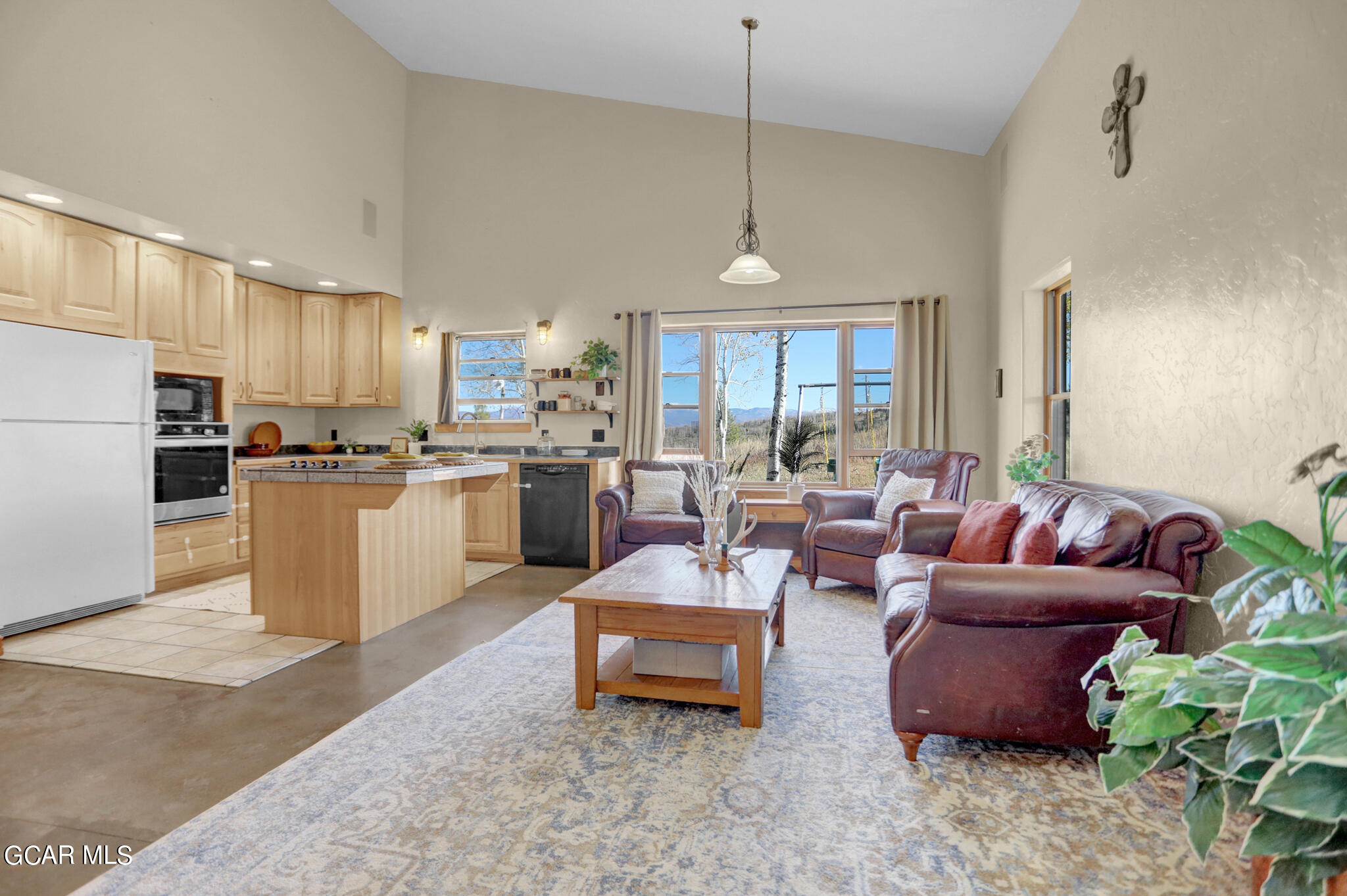 91 3rd Avenue Parshall, CO 80468 - Photo 9 of 48 a living room with furniture kitchen and a chandelier