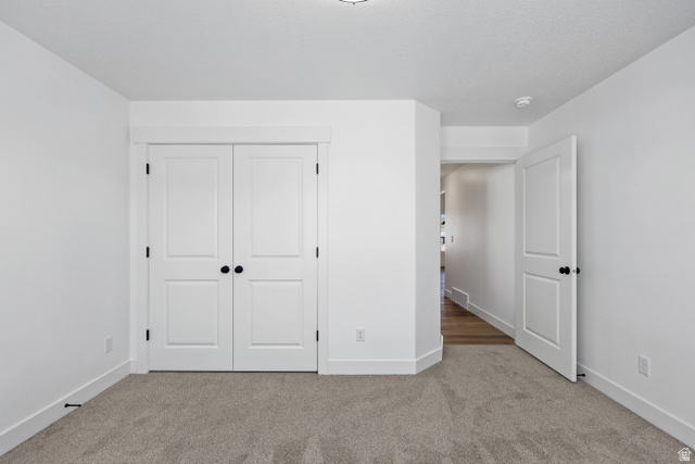 1139 South 4475 West West Point, UT 84015 - Photo 14 of 33 Unfurnished bedroom featuring carpet floors and a closet