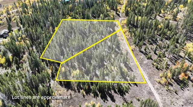 a view of staircase with small plants and wooden fence