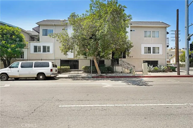a view of a car parked on the side of a street