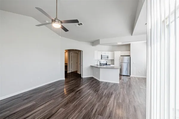 a view of a kitchen with wooden floor a sink and a window