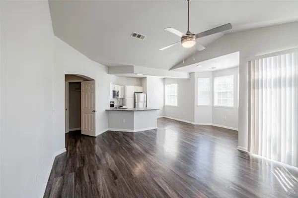a view of a living room with wooden floor and a window