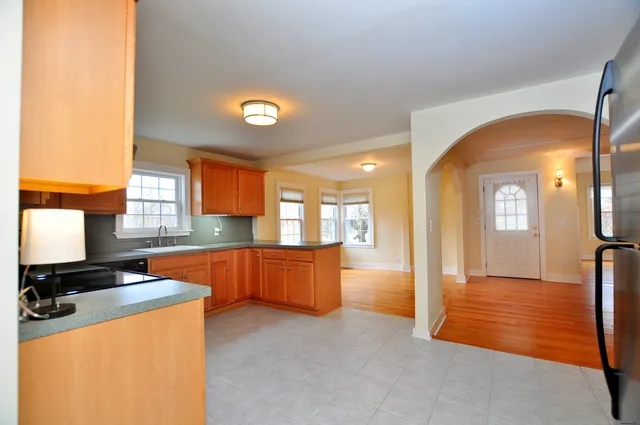 a view of a hallway with wooden shelves