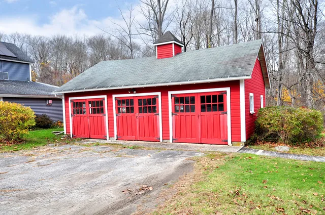 a view of a house with a wooden fence