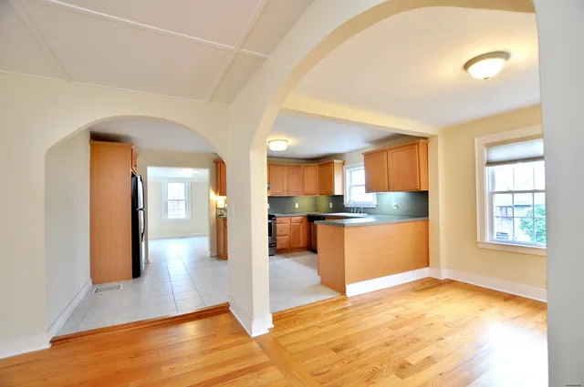 a view of a kitchen with kitchen island and stainless steel appliances