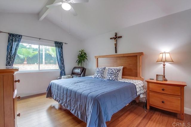 a bedroom with two beds and a potted plant