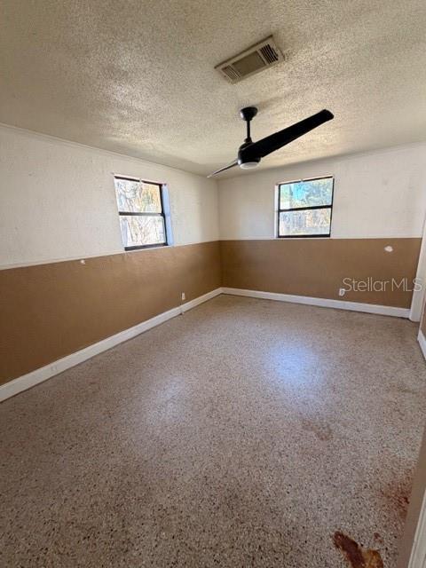 1701 Raleigh Avenue Daytona Beach, FL 32117 - Photo 5 of 16 an empty room with windows and ceiling fan