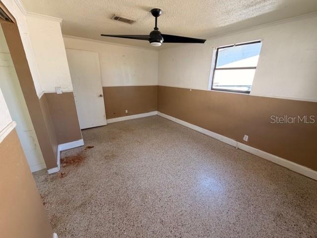 1701 Raleigh Avenue Daytona Beach, FL 32117 - Photo 7 of 16 an empty room with windows and ceiling fan