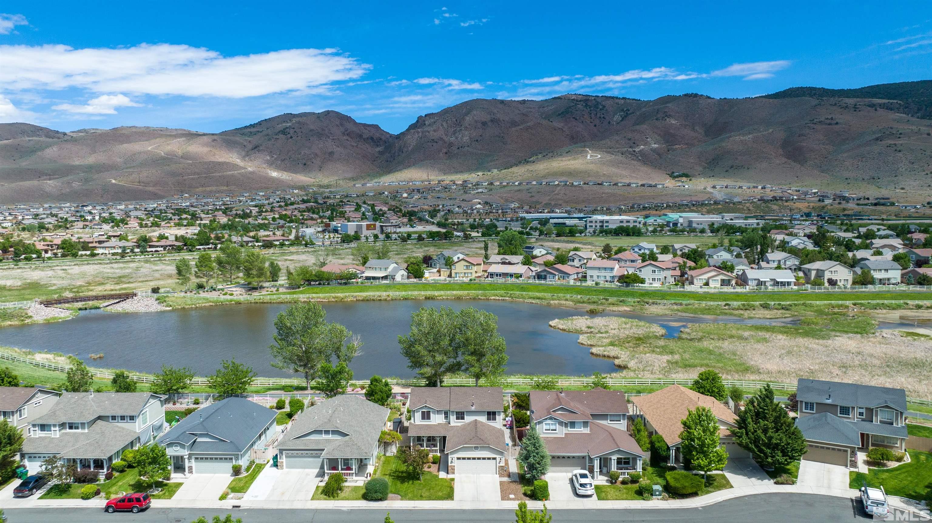 10172 Cascade Falls Court Reno, NV 89521 - Photo 4 of 40 an aerial view of a city with lots of residential buildings ocean and mountain view in back