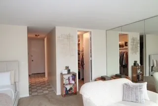 a bedroom with a bed and a mirror