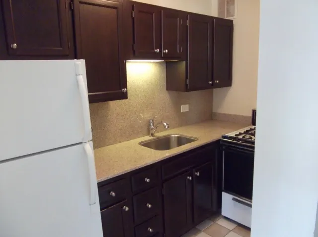 a kitchen with a sink and cabinets