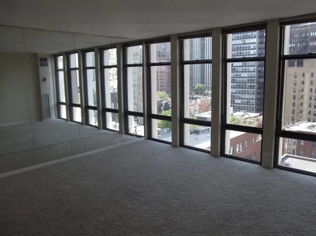 a view of an empty room with windows