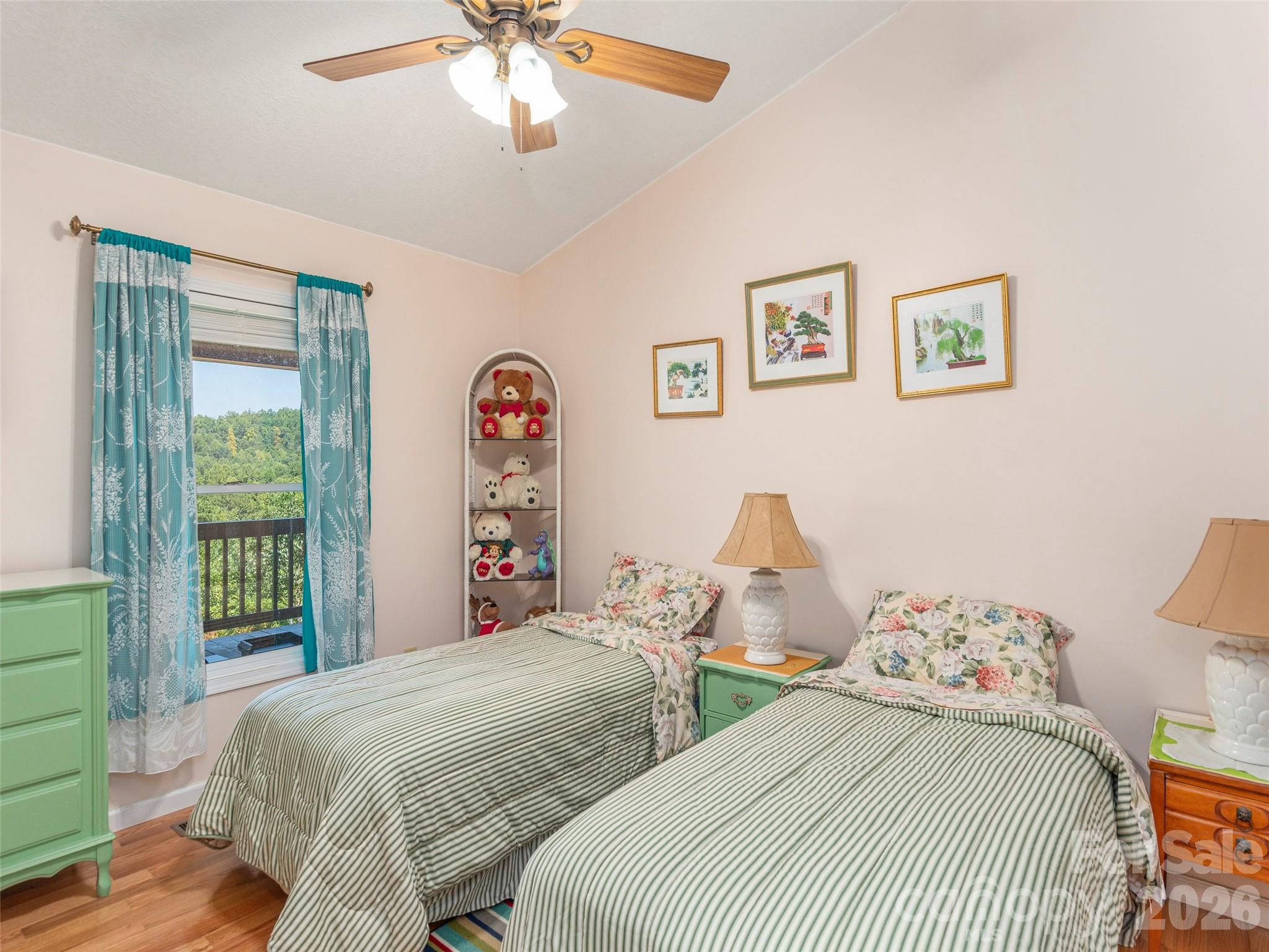 1120 Jacobs Branch Road Franklin, NC 28734 - Photo 16 of 36 a bedroom with two beds and a chandelier