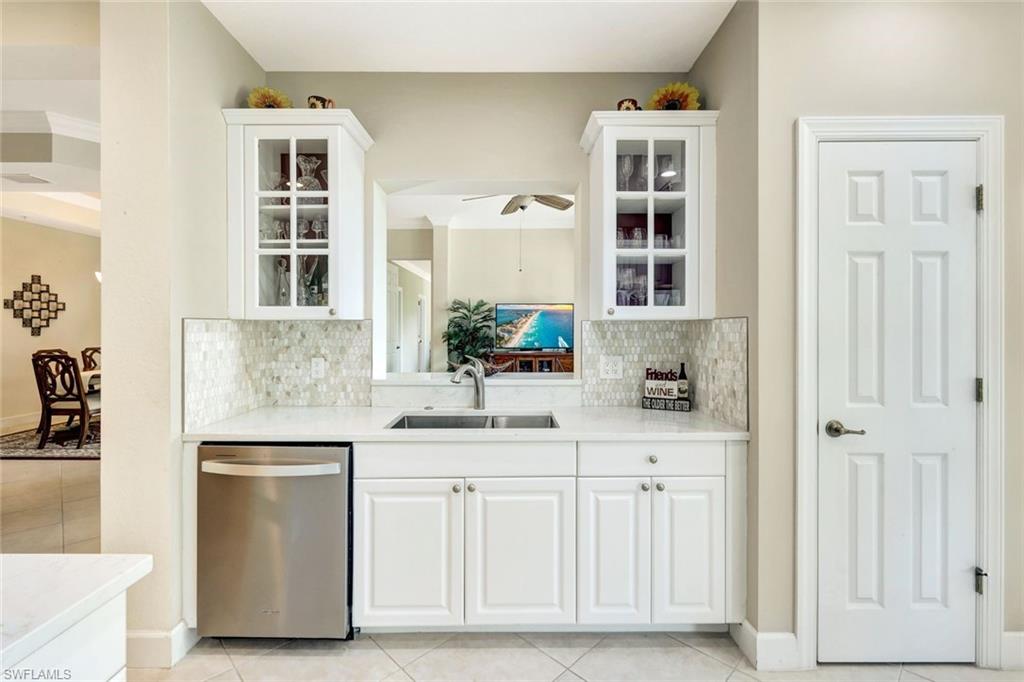 9193 Quartz Lane, Unit 102 Naples, FL 34120 - Photo 12 of 50 a kitchen with cabinets appliances and a sink