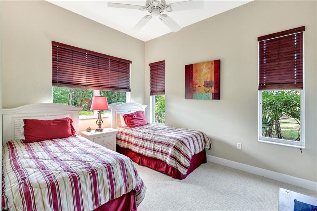 9193 Quartz Lane, Unit 102 Naples, FL 34120 - Photo 26 of 50 a bedroom with two beds and a window