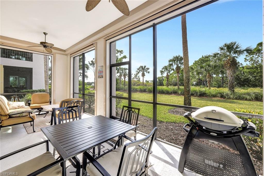 9193 Quartz Lane, Unit 102 Naples, FL 34120 - Photo 28 of 50 a view of a patio with table and chairs potted plants with sky view