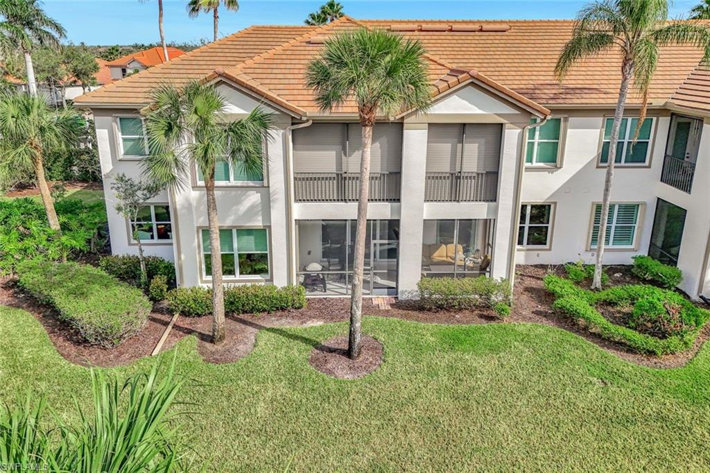 9193 Quartz Lane, Unit 102 Naples, FL 34120 - Photo 30 of 50 a view of a house with backyard porch and sitting area