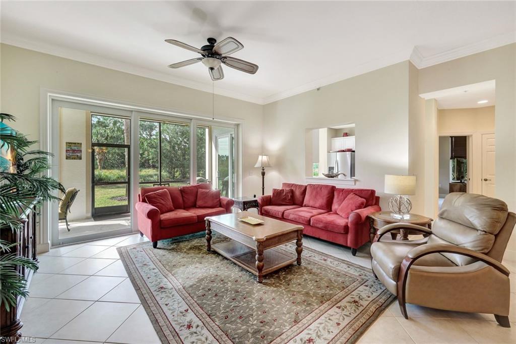 9193 Quartz Lane, Unit 102 Naples, FL 34120 - Photo 6 of 50 a living room with furniture and a large window