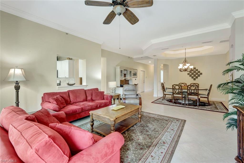 9193 Quartz Lane, Unit 102 Naples, FL 34120 - Photo 7 of 50 a living room with furniture ceiling fan and a rug