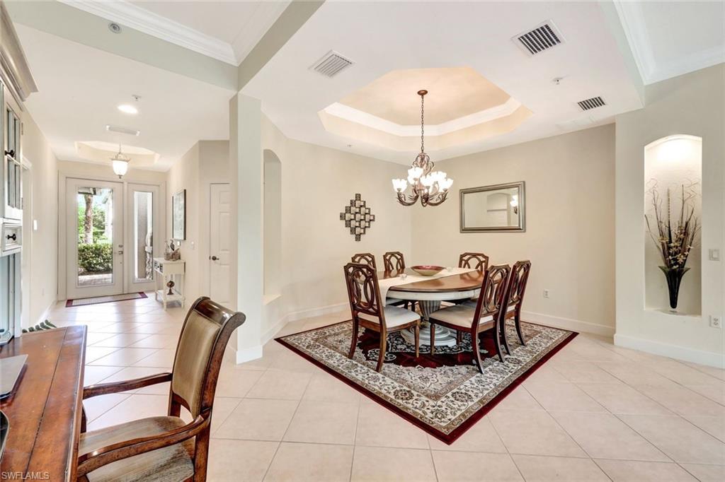 9193 Quartz Lane, Unit 102 Naples, FL 34120 - Photo 9 of 50 a view of a dining room with furniture a chandelier and wooden floor