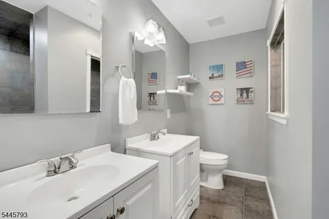 a bathroom with a sink toilet and mirror