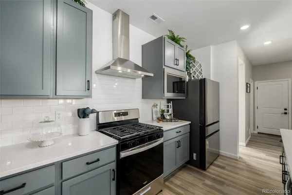 a kitchen with stainless steel appliances a sink stove and refrigerator
