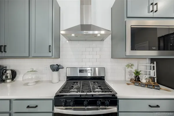 a kitchen with a stove and cabinets