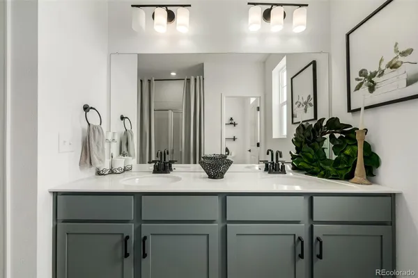 a bathroom with a granite countertop sink vanity and mirror